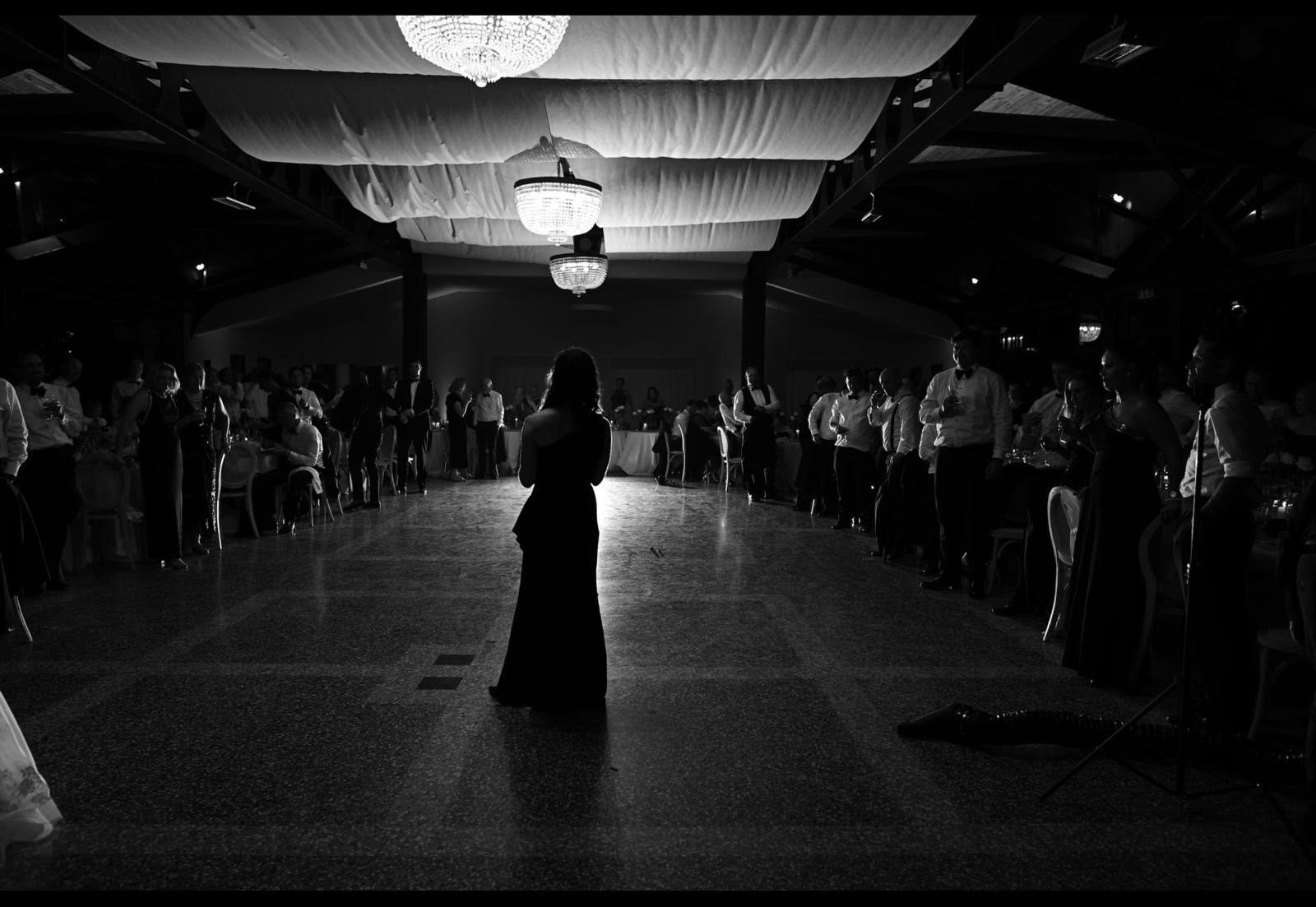 Tanya Little addressing a ballroom of guests at an evening event